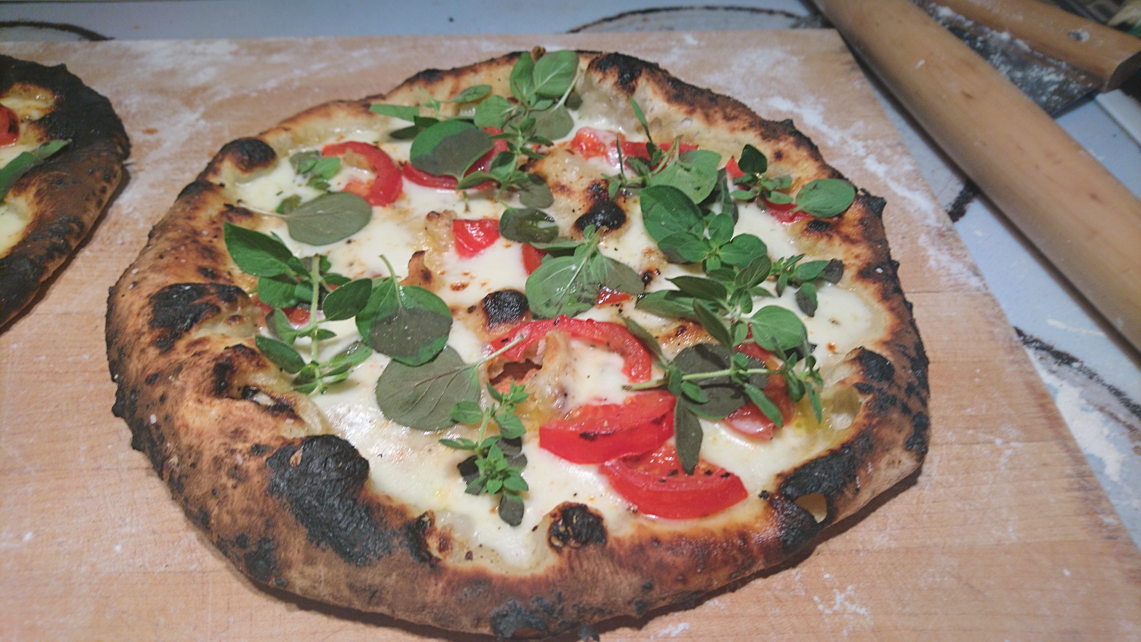 pizza with hand-pulled mozarrella, tomatoes and fresh oregano