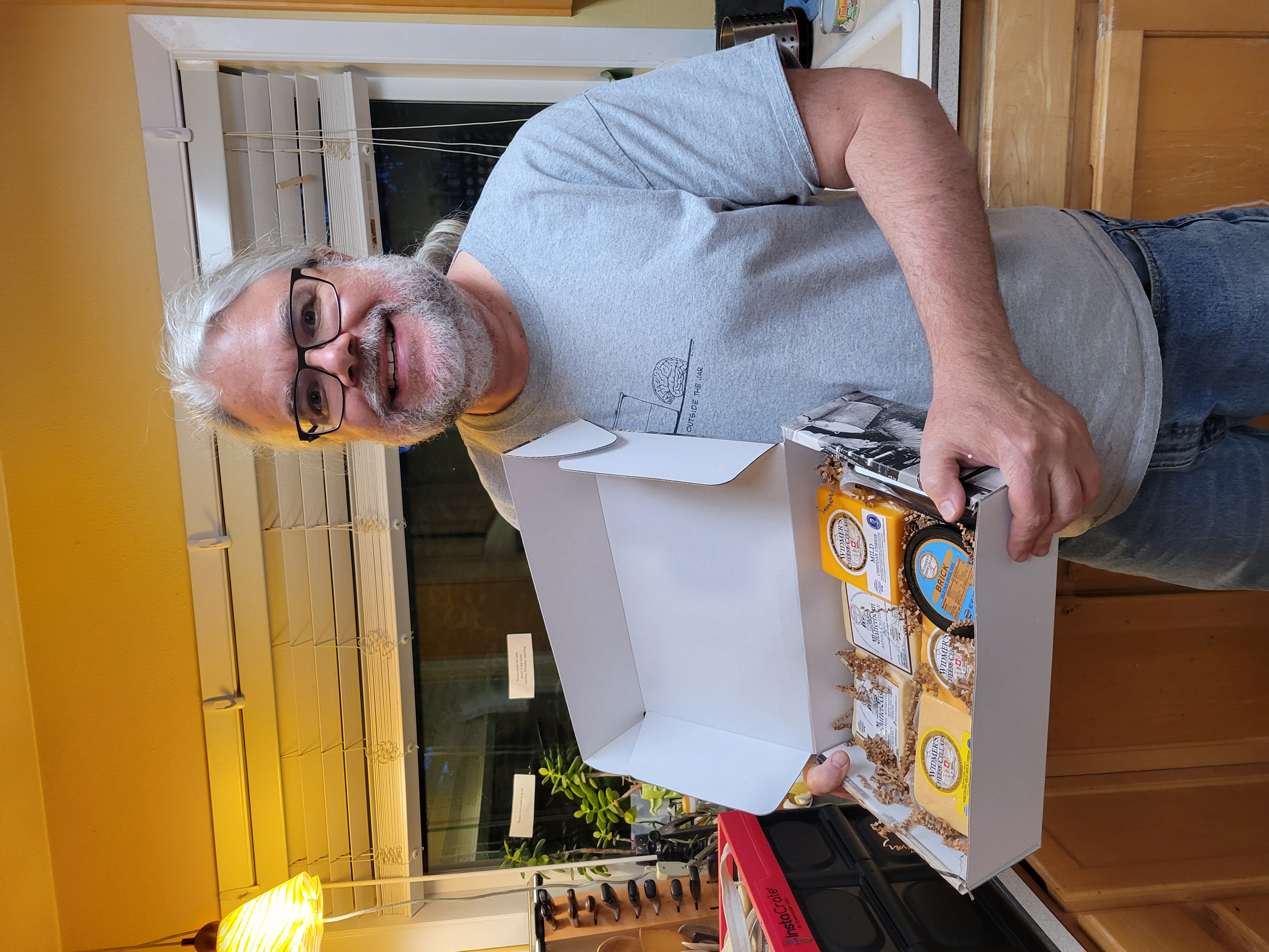 me holding a box full of gift cheese from Widmer's