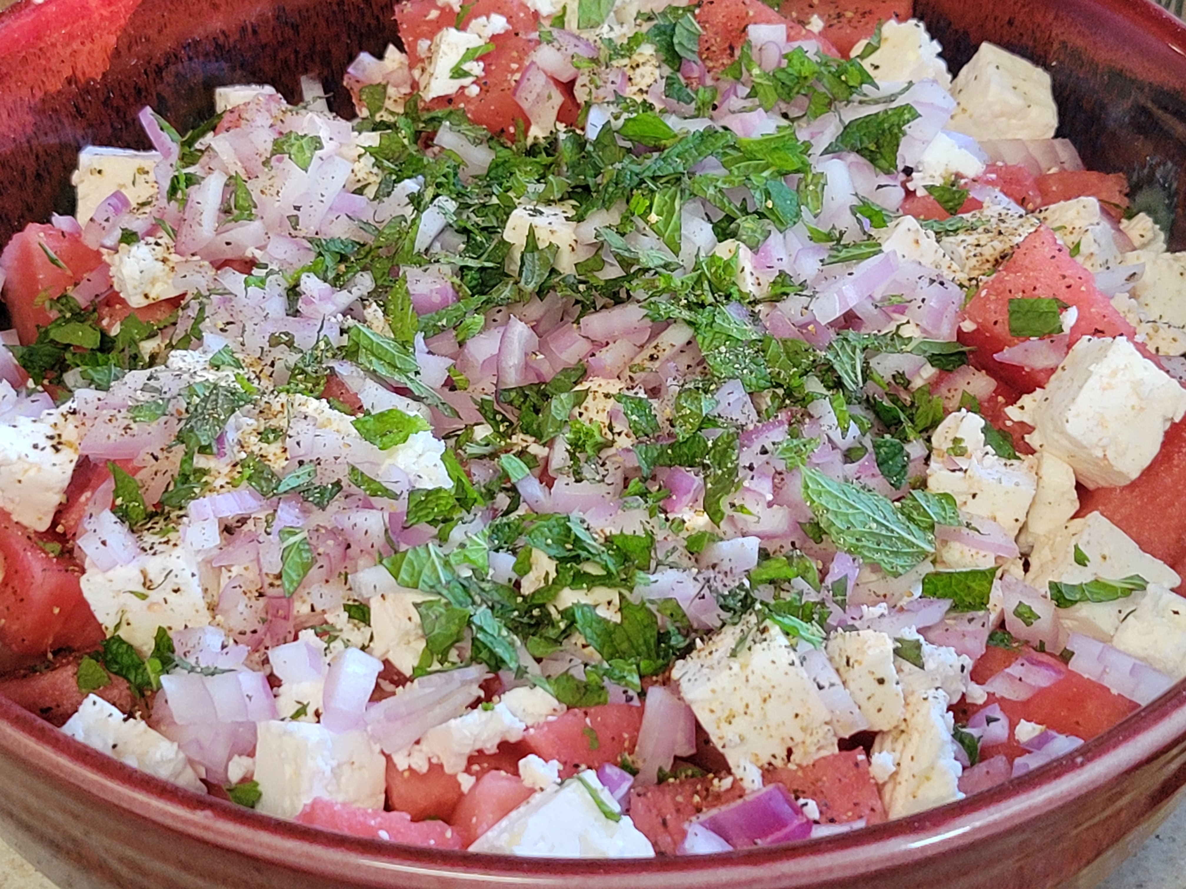 big serving bowl full of watermelon salad