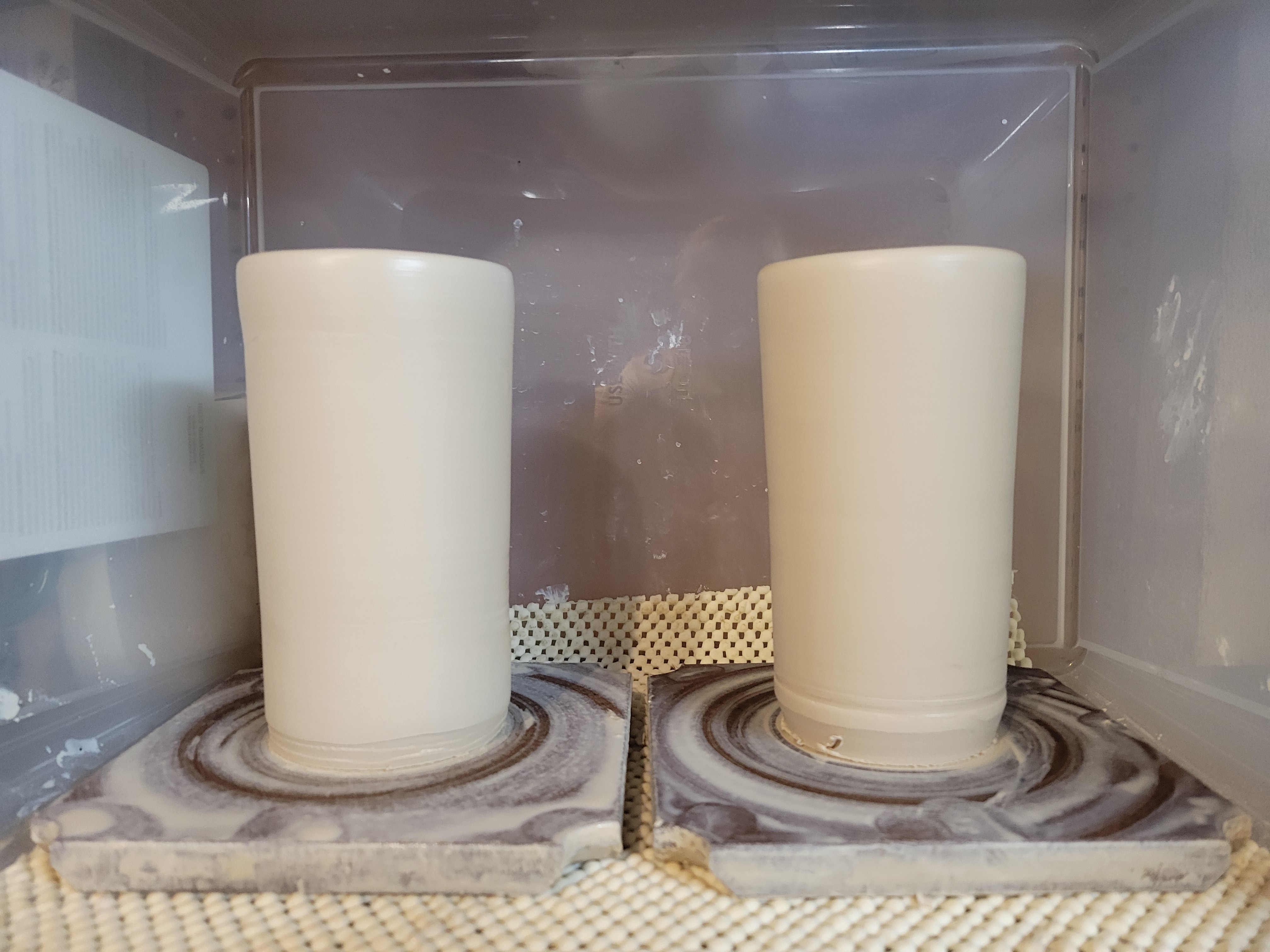 two cylindrical cups on bats