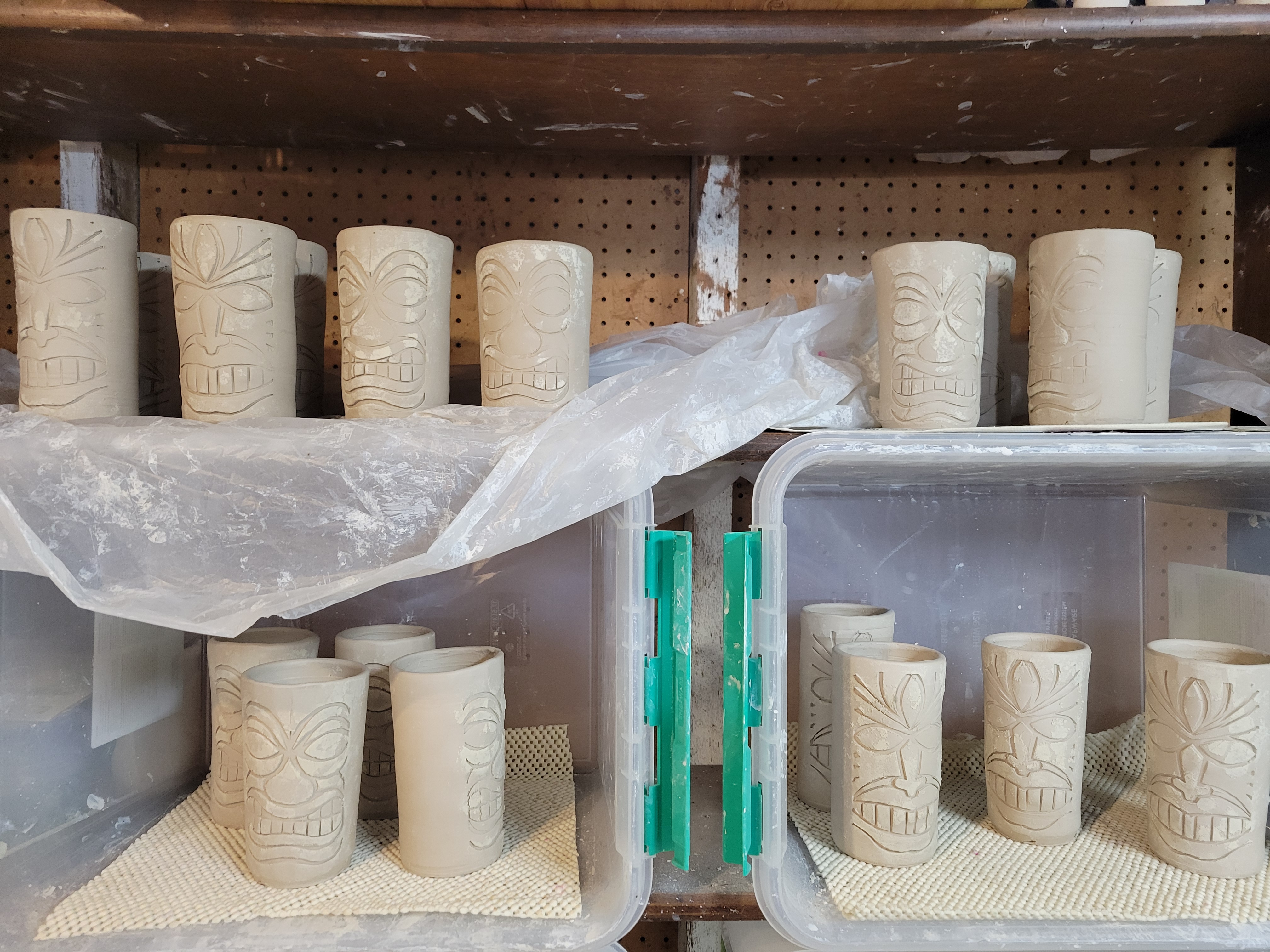 drying shelved full of tiki cups