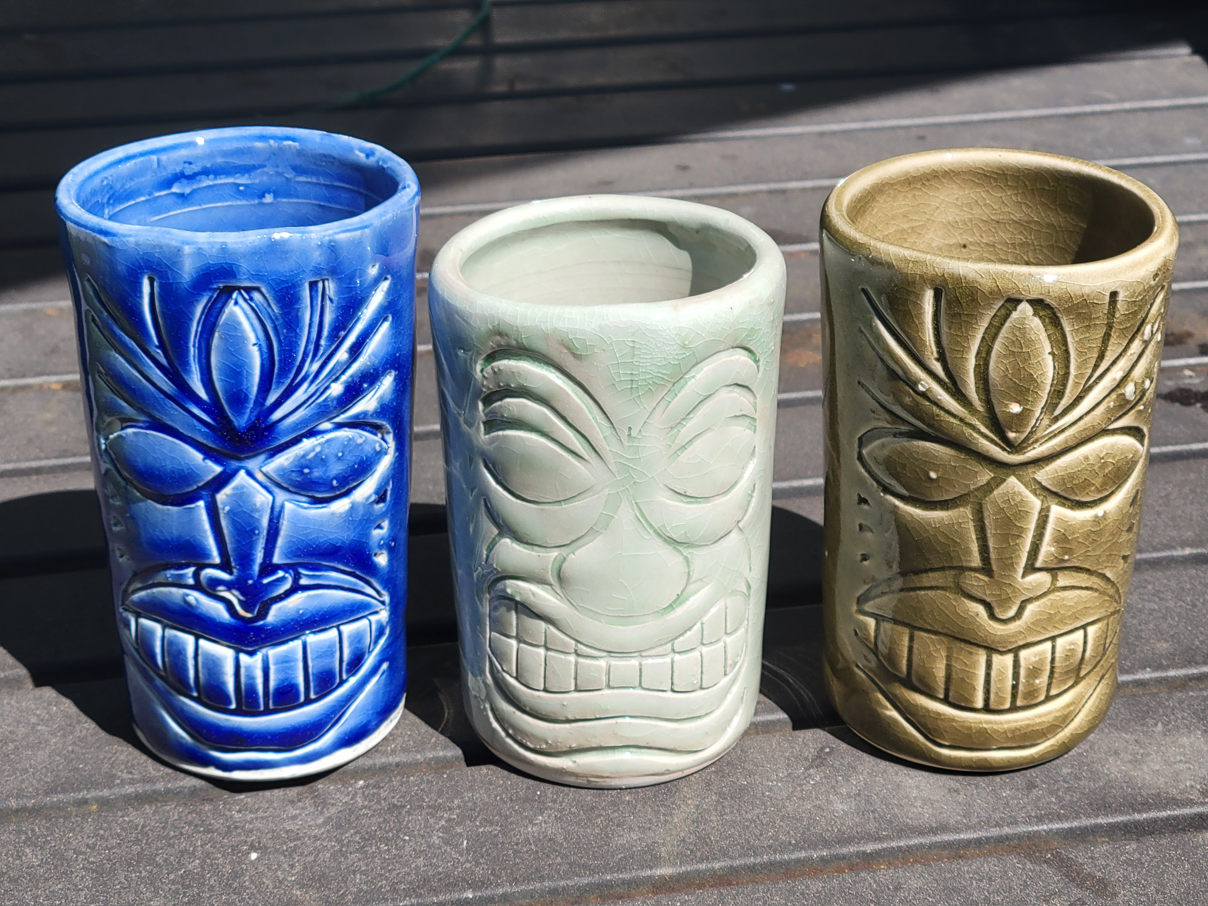 the same picture of three glazed tiki cups