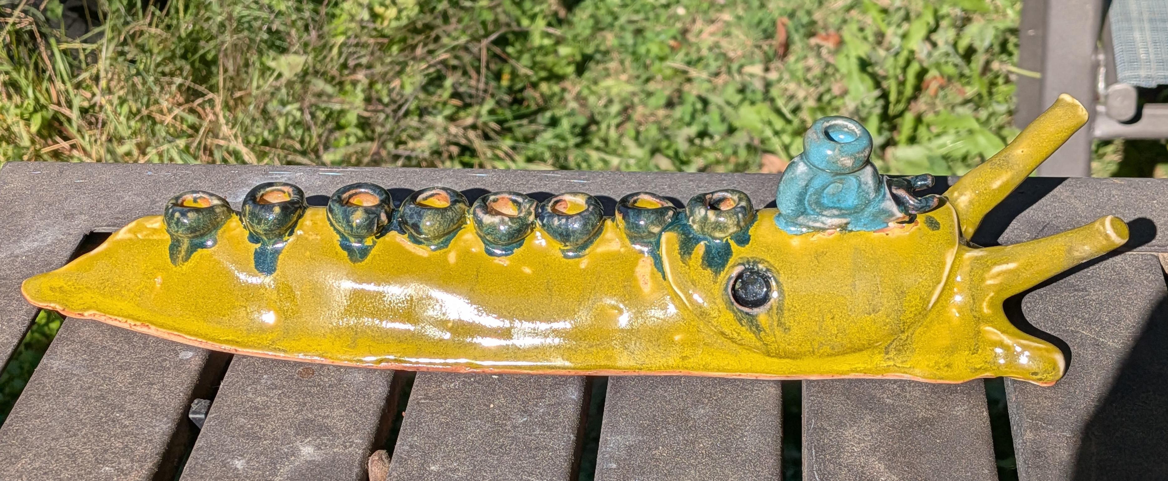 a hanukkah menorah shaped like a large banana slug